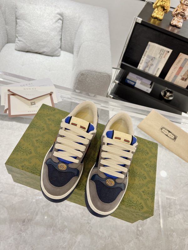 Low-top paneled suede and canvas sneakers in navy and gray.