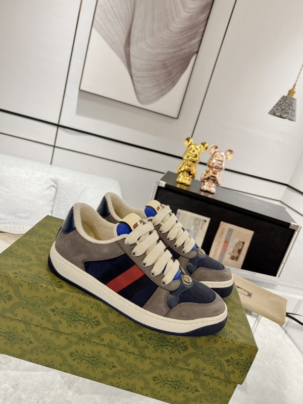 Low-top paneled suede and canvas sneakers in navy and gray.